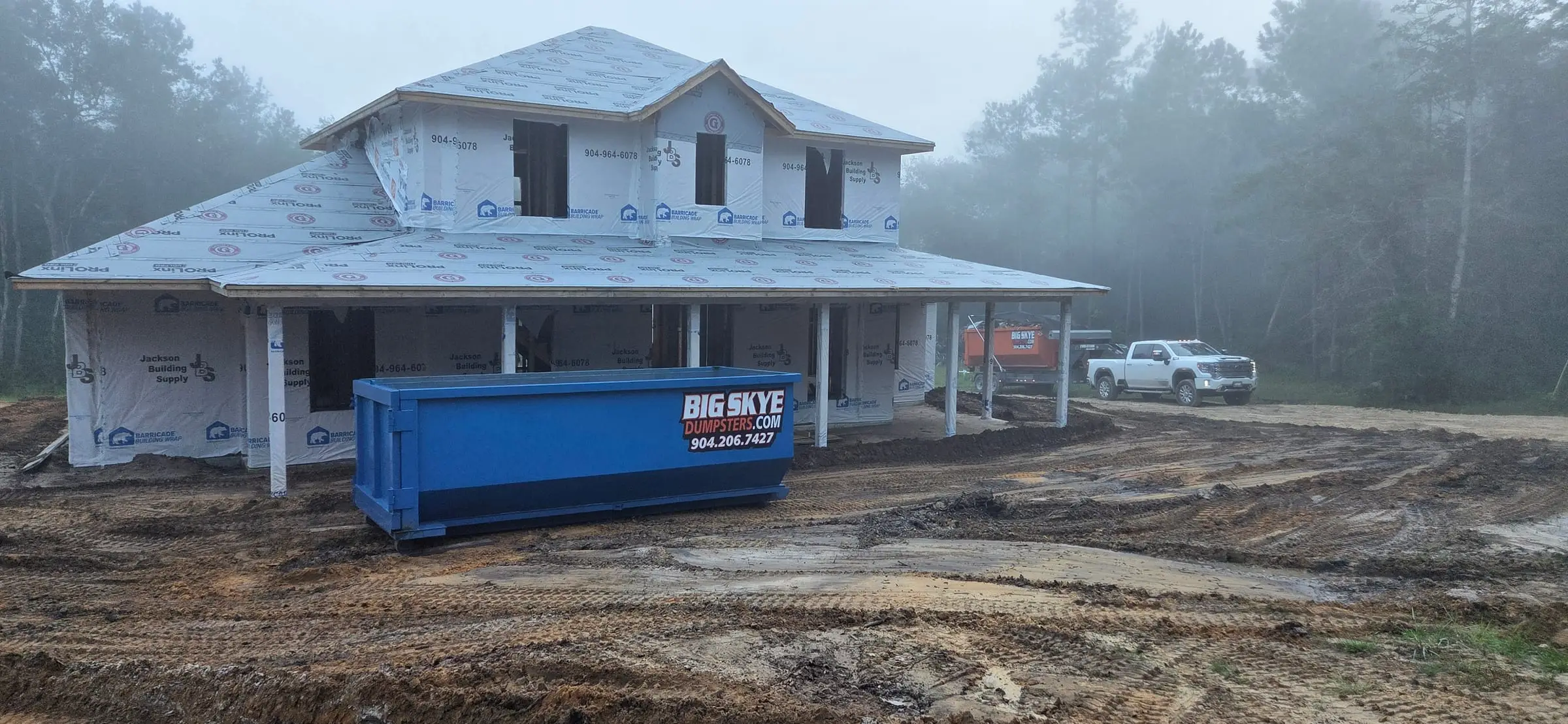Big Skye 20-yard roll-off dumpster in front of a new home under construction